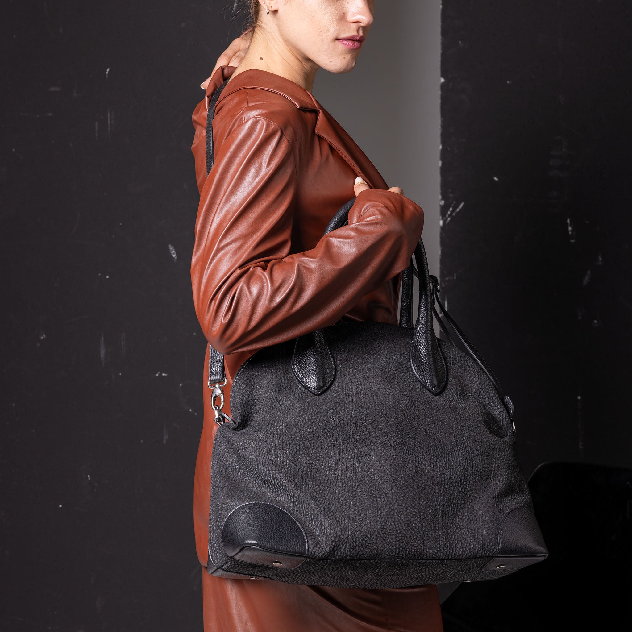 Vesta Tote Black Dotted worn in black cowhide leather with dotted-effect finish