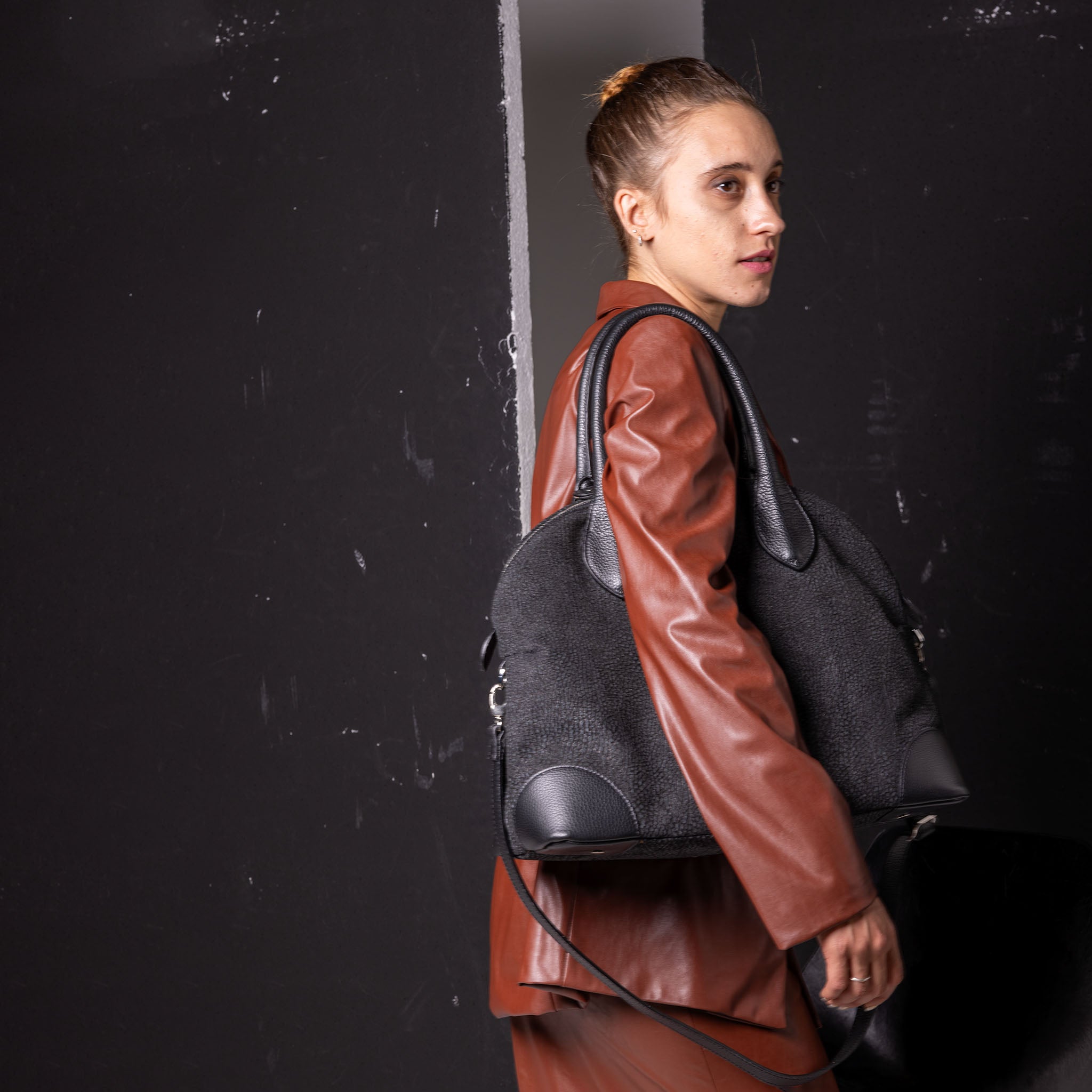 Vesta Tote Black Dotted worn in black cowhide leather with dotted-effect finish