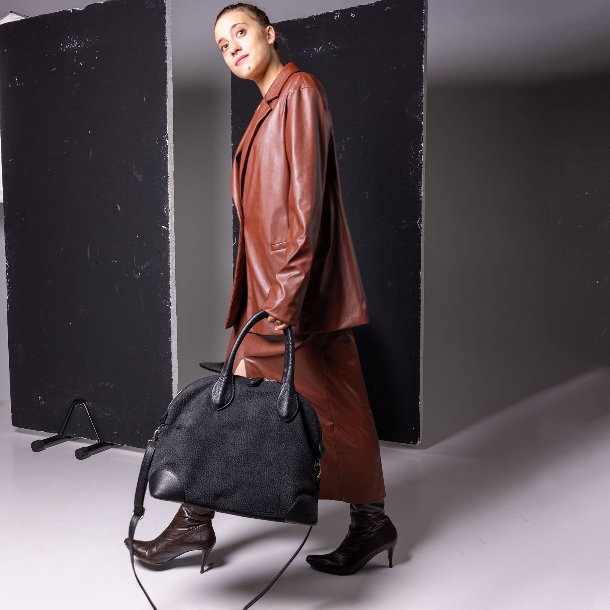 Vesta Tote Black Dotted worn in black cowhide leather with dotted-effect finish