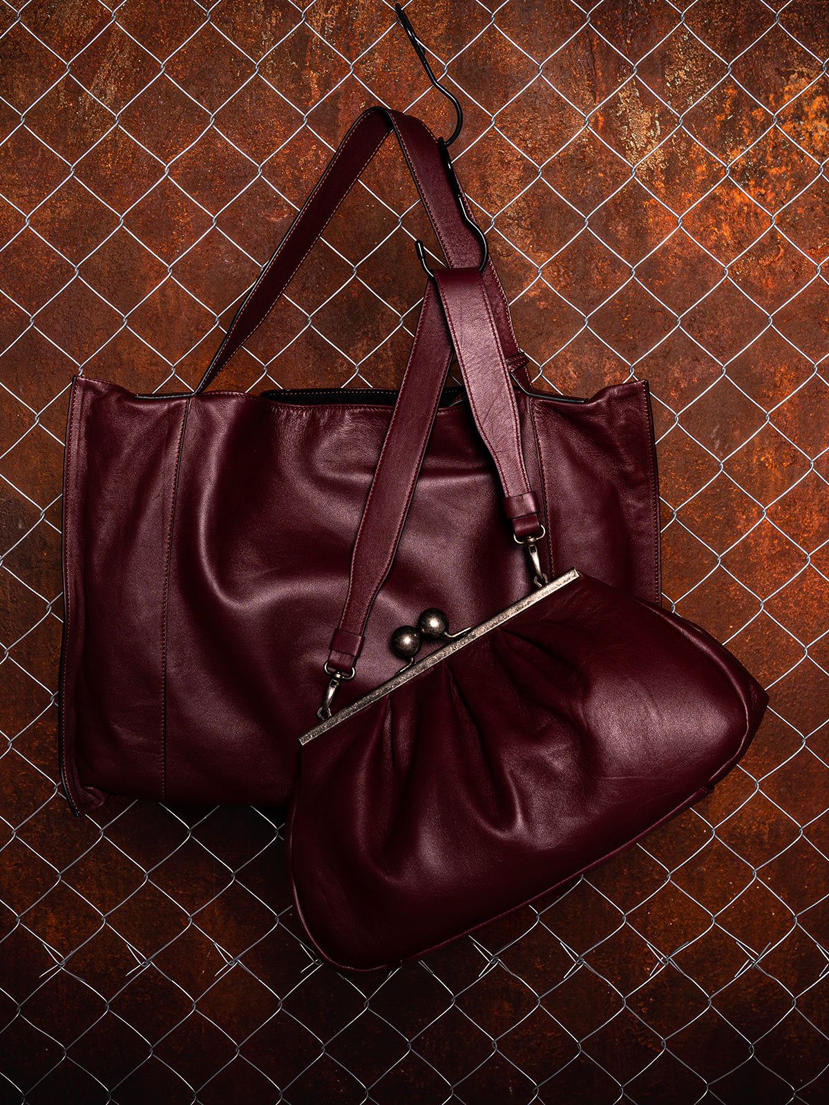 Vittoria Sella Fedra Maxi Bag in Burgundy lambskin alongside Nina Maxi Bag in Burgundy lambskin, side by side.